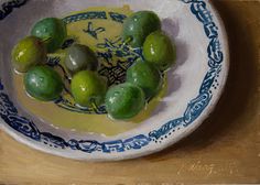 a painting of green olives in a blue and white bowl