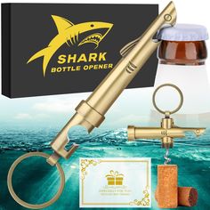 a bottle opener with a shark design on it and a keychain attached to it