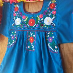 So Cute Mexican Blouse Mew - No Tags- Handmade Fabric: Cotton Care : Hand Wash Size Large : Length: 29” Armpit To Armpit: 23” Size Extra Large : Length: 31” Armpit To Armpit: 24” Embroidery Is Colorful And Unique In Each Blouse .. Blue Fitted Floral Embroidered Top, Blue Fitted Embroidered Short Sleeve Top, Fitted Blue Top With Embroidered Hem, Traditional Blue Tops With Floral Embroidery, Blue Cotton Blouse With Embroidered Neckline, Blue Embroidered Neckline Long Sleeve Top, Blue Short Sleeve Tops With Embroidered Hem, Blue Long Sleeve Top With Embroidered Neckline, Blue Tops With Machine Embroidery For Summer