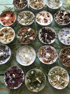 many bowls filled with different types of herbs