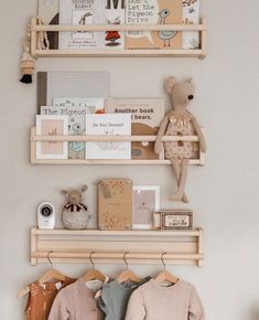 two wooden shelves with books and stuffed animals on them in a child's room