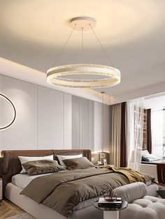 a bedroom with a large bed and a round chandelier