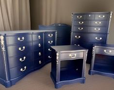 four blue dressers with gold handles and knobs