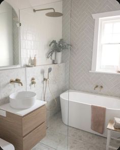 a bathroom with a tub, sink and mirror