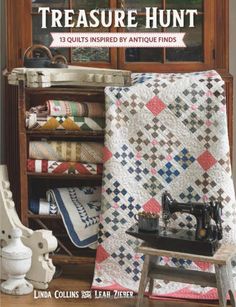 a book with an image of a quilt and sewing machine on it's shelf