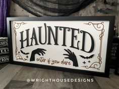 a framed sign that says,'haunted ends to you dare'with bats and witches on it