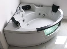 a large white bath tub sitting inside of a bathroom