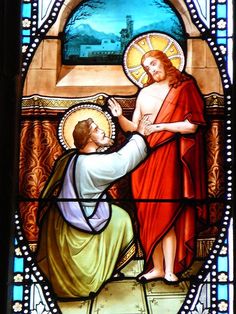 stained glass depicting jesus and the person kneeling down in front of him with his hand on another man's chest