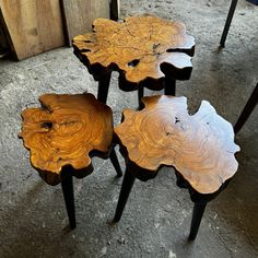 three wooden tables sitting on top of each other in front of a wall and floor