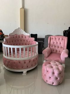 three pink chairs and a baby crib in a room with other furniture on the floor