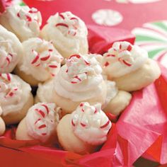 small cookies with white frosting and red sprinkles