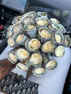 a bunch of rolled up money sitting on top of a table