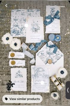 the wedding stationery is laid out on the floor