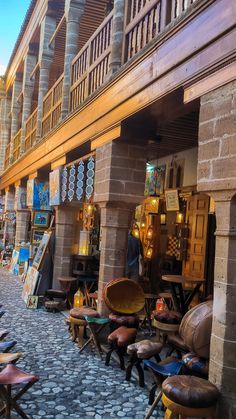 there are many chairs and tables in this street side storefronts that have been set up for sale