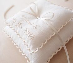 a white square pillow with a bow on it