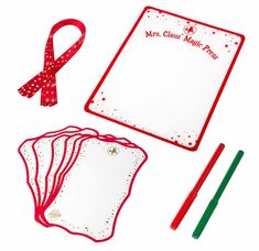 a red and white christmas writing set with paper, markers, pencils and marker