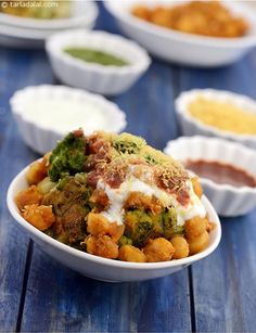 broccoli and other foods are in bowls on a table