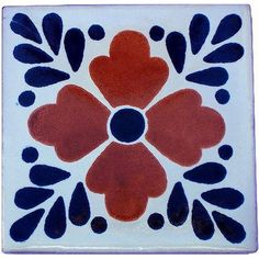 a white and blue tile with red flowers on it