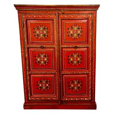 a red and gold painted armoire with ornate designs