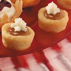 small desserts are arranged on a red plate