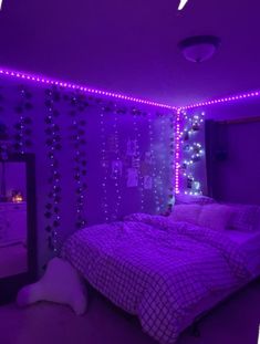 a bedroom with purple lights on the walls