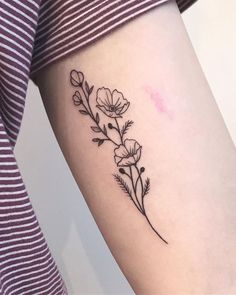 a woman's arm with a flower tattoo on the left side of her body