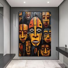 a large painting with many faces on it in a room next to a counter top