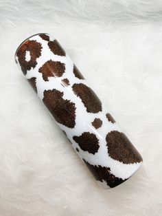 a brown and white animal print tube sitting on top of a white fur covered floor