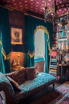 a living room filled with lots of furniture and bookshelves next to a window