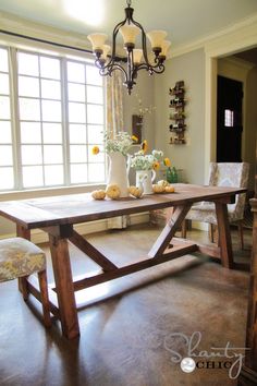 a dining room table and chairs in front of a window