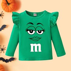 This Coated Candy "M" Tutu Set/Costume is pure sweetness! It's made of premium cotton for a comfortable fit, perfect for your little munchkin on Halloween! Make sure your Halloween night is poppin' with this oh-so-cute set, guaranteed to have your kid looking like the real candy coated deal. Long Sleeve T-shirt With Character Print For Playtime, Fun Long Sleeve T-shirt For Playtime, Green Cartoon Print Top For Fall, Green Cartoon Print Tops For Fall, Green Long Sleeve Cartoon Print Top, Green Long Sleeve Top With Cartoon Print, Playful T-shirt For Fall Playtime, Playful T-shirt For Playtime In Fall, Funny Character Print Tops For Playtime