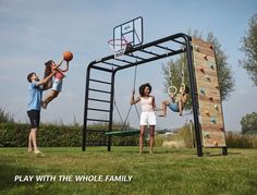 three children playing with a basketball hoop and climbing wall in the yard, while an adult watches