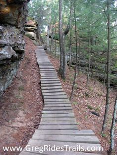 wooden steps lead up to the top of a cliff