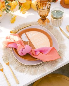 a table set with place settings, napkins and utensils for an elegant dinner