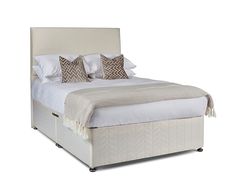 a bed with white sheets and pillows on it's headboard, in front of a white background