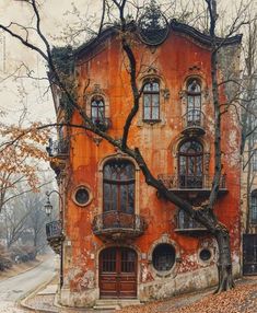 an old building with many windows and balconies on the outside, surrounded by leafy trees