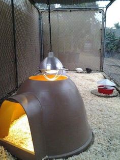 a large brown dog house sitting inside of a cage