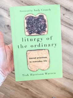 a person holding up a book about the story of the ordinary bread sandwich in everyday life