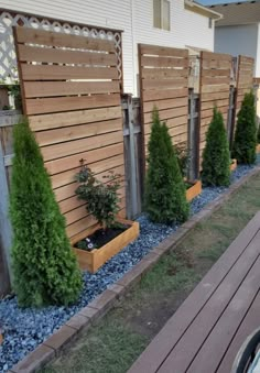 a row of wooden planters in front of a house