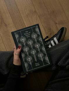 a person sitting on the floor holding a book