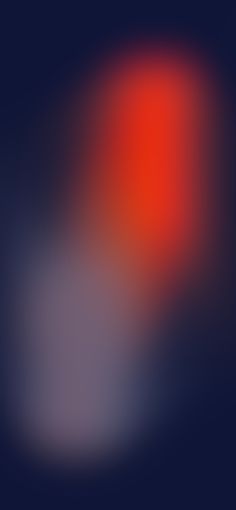 blurry image of an orange and red light on a dark blue background with space for text