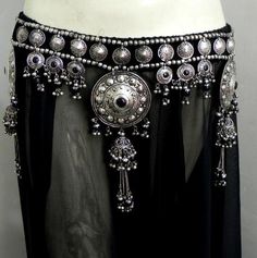 a woman's belly belt with silver and black beads