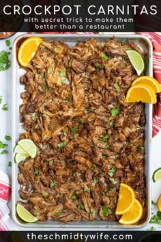 an image of mexican shredded beef with limes and cilantro on the side