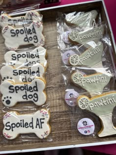 decorated cookies in the shape of dogs and bones on display at a petting event