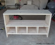 a wooden shelf sitting in the middle of a garage