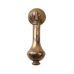 an antique brass door handle with a ball on the front and back end, isolated against a white background