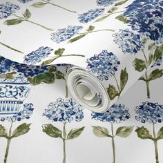 a blue and white wallpaper with flowers on it