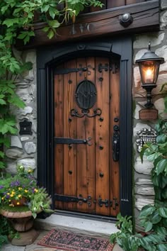 a wooden door in front of a stone building with plants growing on the outside wall