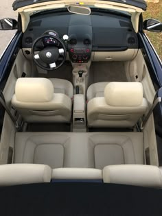 the interior of a small car with four seats and dashboards, including one steering wheel