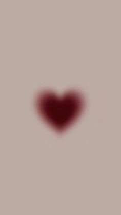 a heart shaped object is shown in the middle of a blurry image with red highlights